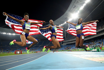 American athletes celebrate with flags after the Women's 100m Hurdles in Rio 2016